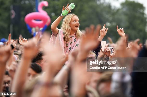 Festival-goers enjoy the music on the third day of the TRNSMT music Festival on Glasgow Green, in Glasgow, Scotland on July 9, 2017. / AFP PHOTO /...