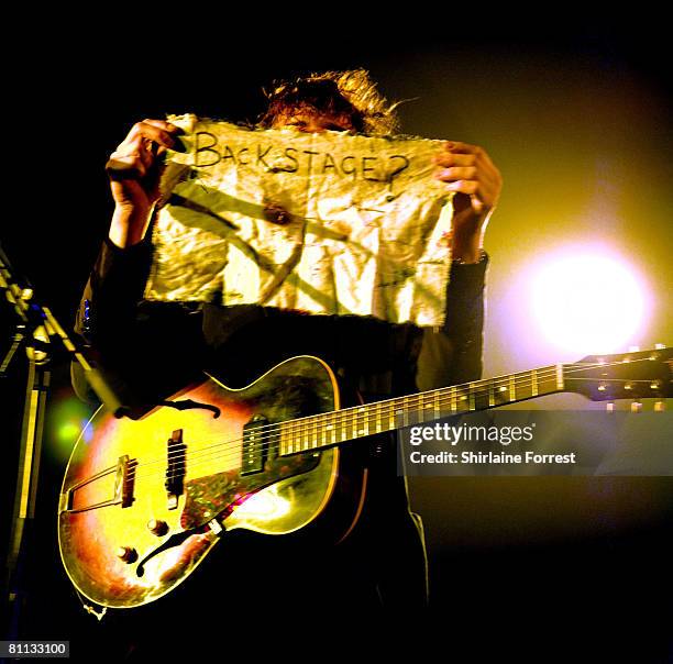 Pete Doherty holds fan mail while performing solo accoustic show at Manchester Academy on May 17, 2008 in Manchester, England.