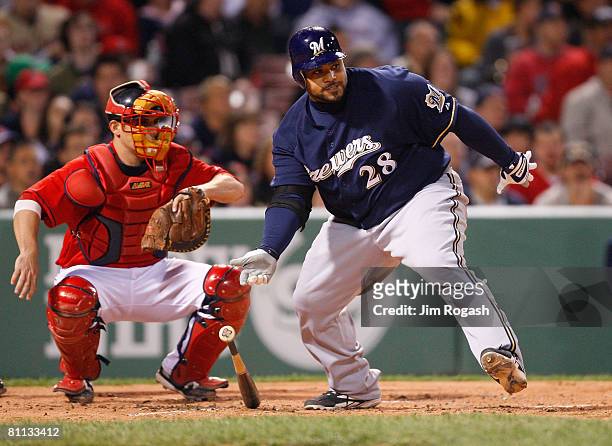 Catcher Kevin Cash of the Boston Red Sox watches as Prince Fielder of the Milwaukee Brewers makes contact during the second game of a doubleheader at...