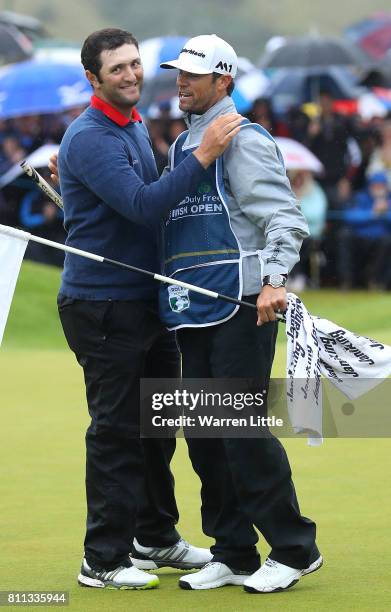 Jon Rahm of Spain embraces his caddie Adam Hayes after his victory on the 18th green during the final round of the Dubai Duty Free Irish Open at...