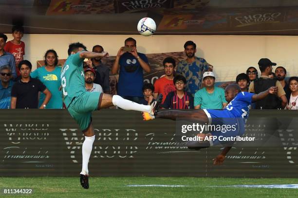 Portugal's Luis Boa Morte vies with Pakistan's Ahmad on July 9, 2017 during a friendly football match in Lahore. Eight of football's biggest stars,...