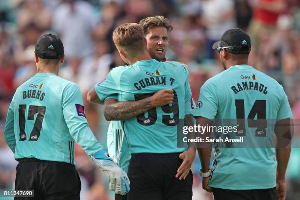 Captain Jade Dernbach of Surrey hugs last over bowler Tom Curran after Surrey win a last ball thriller during the NatWest T20 Blast match at The Kia...