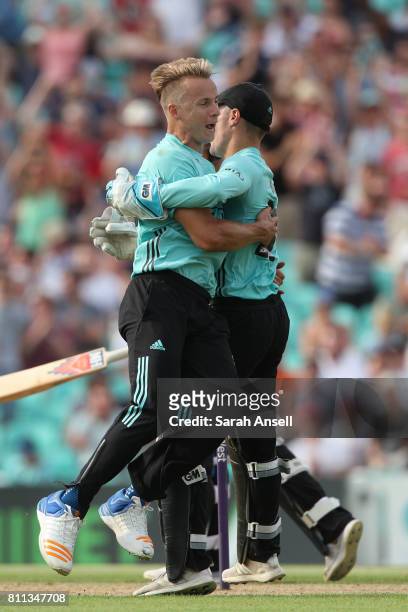 Bowler Tom Curran celebrates with wicket keeper Rory Burns after Surrey win a last ball thriller during the NatWest T20 Blast match at The Kia Oval...
