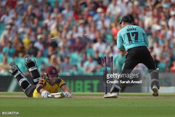 Rory Burns of Surrey runs out Corey Anderson of Somerset for 81 runs during the NatWest T20 Blast match at The Kia Oval on July 9, 2017 in London,...