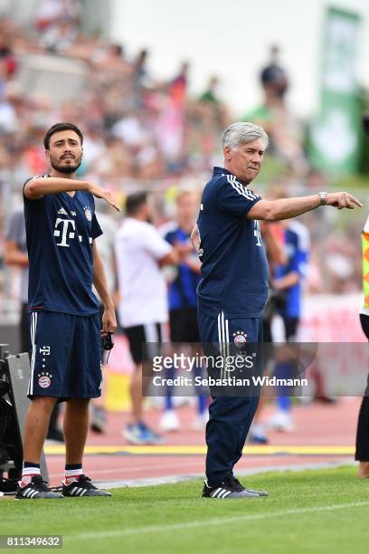 Head coach Carlo Ancelotti and assistant coach Davide Ancelotti gesture during the preseason friendly match between FSV Erlangen-Bruck and Bayern...