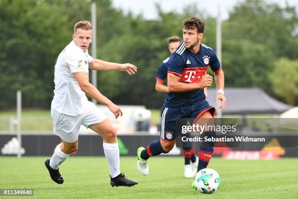 Juan Bernat of FC Bayern Muenchen and Jan Sperber of FSV Erlangen-Bruck compete for the ball during the preseason friendly match between FSV...