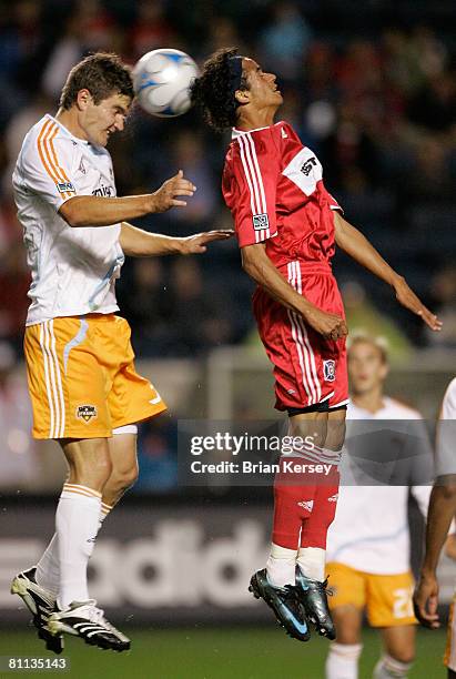 Bobby Boswell of the Houston Dynamo and Calen Carr of the Chicago Fire go up for a header during the first half at Toyota Park on May 17, 2008 in...