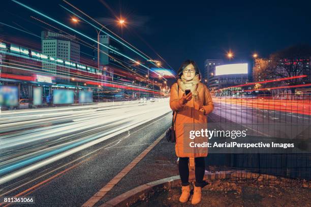 woman using smart phone in urban city - light trail people stock pictures, royalty-free photos & images