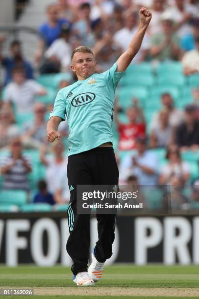 Sam Curran of Surrey celebrates after taking the wicket of Somerset's Craig Overton during the NatWest T20 Blast match at The Kia Oval on July 9,...