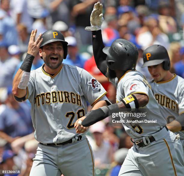 Francisco Cervelli of the Pittsburgh Pirates celebrates hitting a grand slam home run in the 1st inning against the Chicago Cubs with teammate Josh...