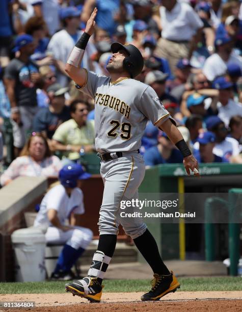Francisco Cervelli of the Pittsburgh Pirates celebrates hitting a grand slam home run in the 1st inning against the Chicago Cubs at Wrigley Field on...