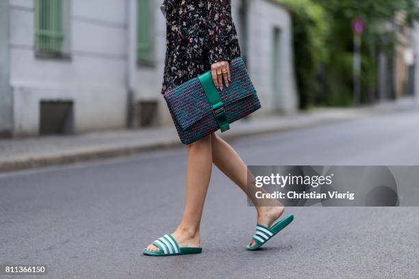 Lisa Hahnbueck wearing IRO flower hippie dress, Chanel tweed clutch, Adidas green velvet adiletten pool slides during the Mercedes-Benz Fashion Week...