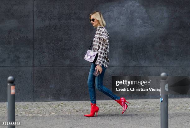 Lisa Hahnbueck wearing J Brand jeans, SJYP printed cotton blend shirt with statement sleeves, Balenciaga x Colette knife boots limited edition, Prada...