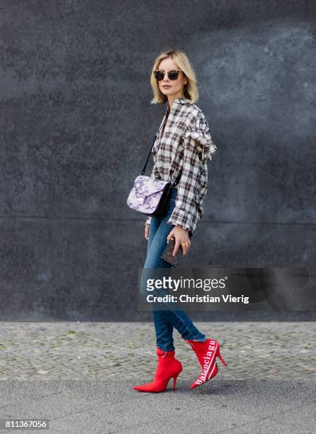 Lisa Hahnbueck wearing J Brand jeans, SJYP printed cotton blend shirt with statement sleeves, Balenciaga x Colette knife boots limited edition, Prada...