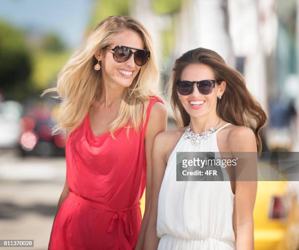 two women walking down a shopping street - beverly hills shopping stock pictures, royalty-free photos & images