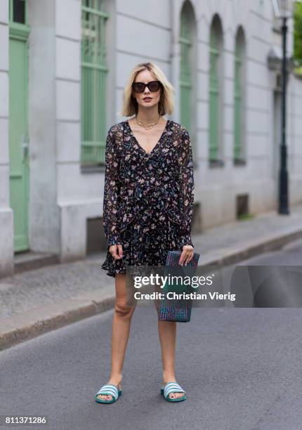 Lisa Hahnbueck wearing IRO flower hippie dress, Chanel tweed clutch, Adidas green velvet adiletten pool slides during the Mercedes-Benz Fashion Week...