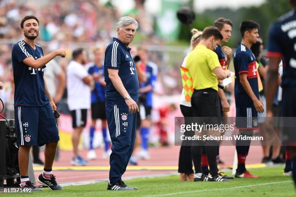 Head coach Carlo Ancelotti and assistant coach Davide Ancelotti gesture during the preseason friendly match between FSV Erlangen-Bruck and Bayern...