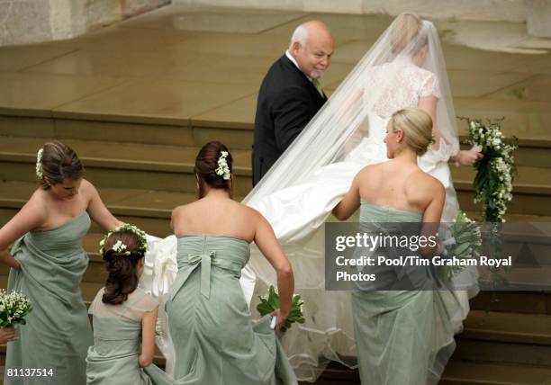 Bride Autumn Kelly arrives in the rain with her father Brian Kelly and her bridesmaids for her wedding ceremony at St George's Chapel in Windsor...
