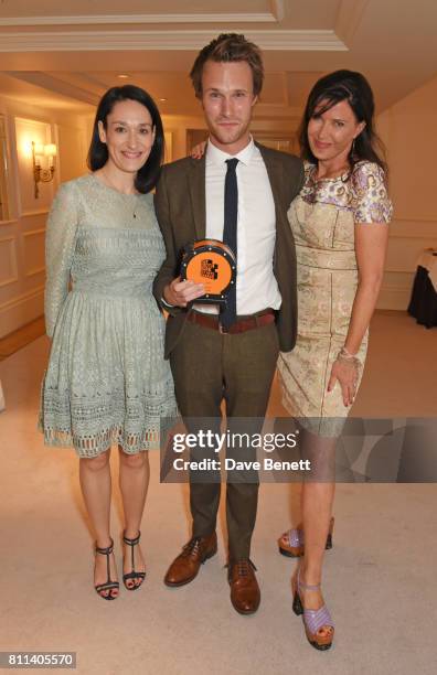 Sian Clifford and Hugh Skinner, winners of the Comedy award for "Fleabag", pose with presenter Ronni Ancona in the winners room at The South Bank Sky...