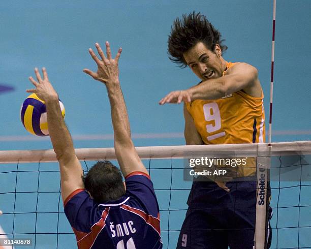 Dutch volleyball player Jeroen Trommel spikes the ball during the European Championship qualifying round against Slovenia in Rotterdam on May 18,...