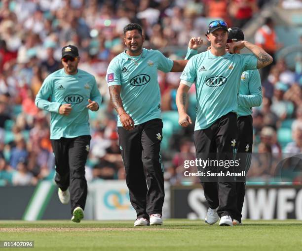 Ravi Rampaul of Surrey celebrates with teammates after taking the wicket of Somerset's Lewis Gregory during the NatWest T20 Blast match at The Kia...