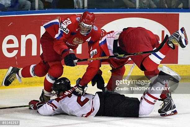 Canada's Dan Hamhuis gets checked by Russia Sergei Fedorov and Alexander Ovechkin in the gold medal game of the 2008 IIHF World Hockey Championships...