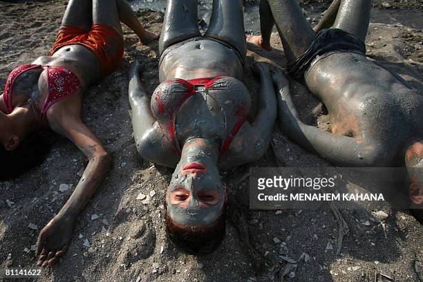 Group of Israeli hikers cover their bodies with mineral-rich mud on the shores of the Dead Sea in Israel on May 18, 2008. At 420 metres below sea...