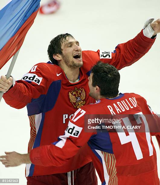 Russia's Alexander Ovechkin celebrates with ateammate after his team scored the winning goal against Canada 5-4 in overtime at the gold medal game of...