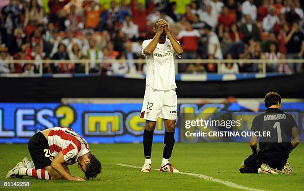 Sevilla's Kanoute gestures with Athletic's Aitor Ocio and goalkeeper Armando during the Spanish league football match at the Sanchez Pizjuan stadium...