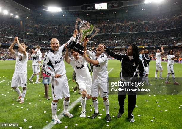 Dutchmen Arjen Robben , Ruud van Nistelrooy and Wesley Sneijder of Real Madrid hold alloft the La Liga trophy flanked by their teammate Royston...
