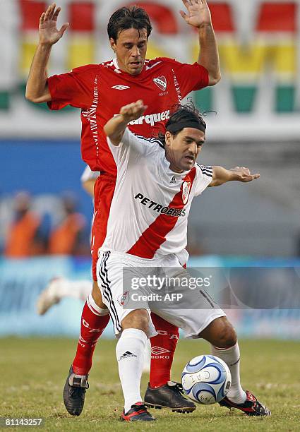 River Plate's Ariel Ortega vies for the ball with Lucas Pusineri of Independiente during their Argentina first division football match in Buenos...