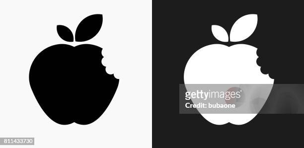 bitten apple icon on black and white vector backgrounds - apple bite out stock illustrations