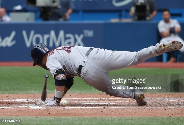 Yulieski Gurriel of the Houston Astros falls after being hit by pitch in the seventh inning during MLB game action against the Toronto Blue Jays at...