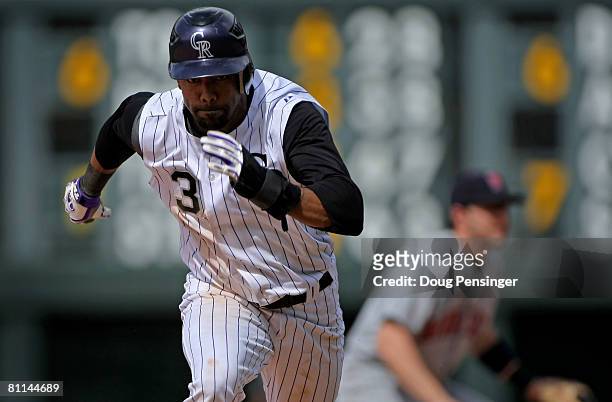 Willy Taveras of the Colorado Rockies steal third base against the Minnesota Twins in the eighth inning during Interleague MLB action at Coors Field...