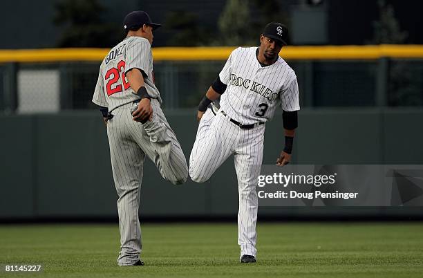 Carlos Gomez of the Minnesota Twins and Willy Taveras of the Colorado Rockies stretch before the the game during Interleague MLB action at Coors...