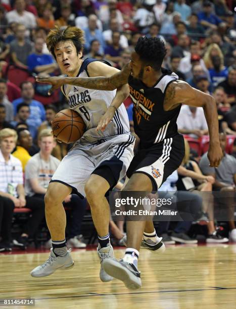 Ding Yanyuhang of the Dallas Mavericks is fouled by Derrick Jones Jr. #10 of the Phoenix Suns during the 2017 Summer League at the Thomas & Mack...