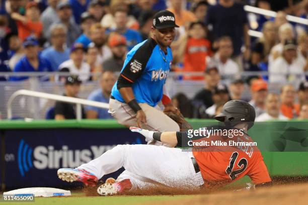 Chance Sisco of the Baltimore Orioles and the U.S. Team slides into third on an RBI triple in the second inning against the World Team during the...