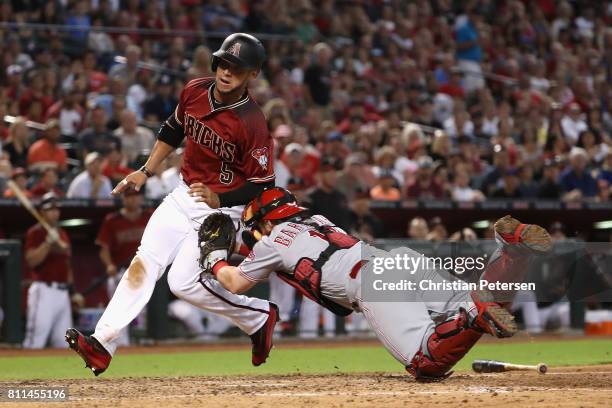 Gregor Blanco of the Arizona Diamondbacks is tagged out by catcher Tucker Barnhart of the Cincinnati Reds as he attempts to score during the fifth...