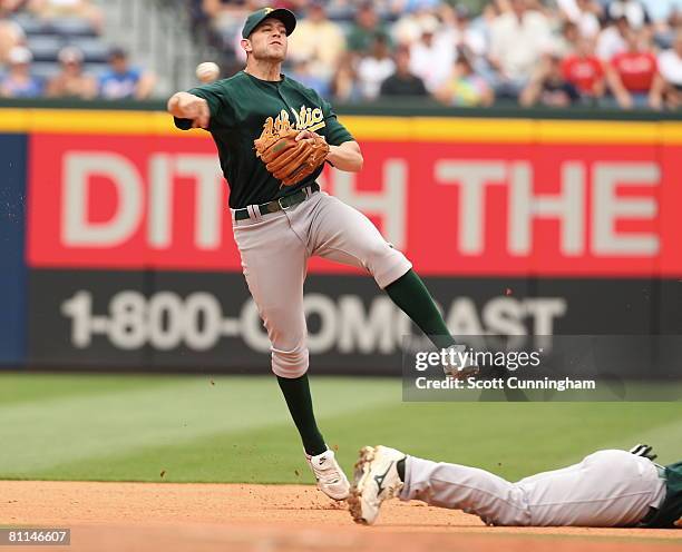 Bobby Crosby of the Oakland Athletics throws out a runner against the Atlanta Braves at Turner Field on May 18, 2008 in Atlanta, Georgia. The Braves...