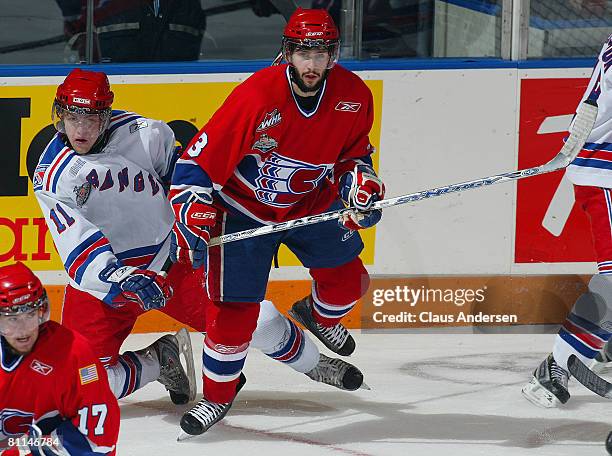 Nick Spaling of the Kitchener Rangers is knocked to the ice by Trevor Glass of the Spokane Chiefs in a Memorial Cup round robin game on May 18, 2008...