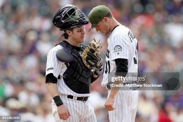 Catcher Ryan Hannigan and starting pitcher Kyle Freeland of the Colorado Rockies confer in the eighth inning against the Chicago White Sox at Coors...