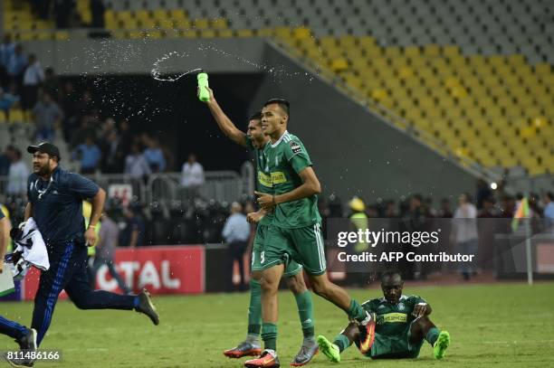 Libyas Al Ahly Tripoli footballers celebrate at the end of their match against Egypt's Zamalek during their African Champions League group stage...