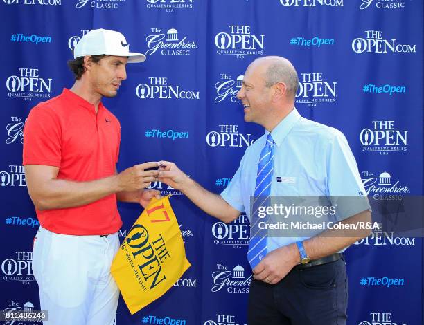 Jamie Lovemark is presented with a player badge and a hole flag by Charlie Maran of the Championship Committee after qualifying for the Open...