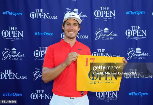 Jamie Lovemark holds a hole flag after qualifying for the Open Championship afterthe fourth and final round of The Greenbrier Classic held at The Old...