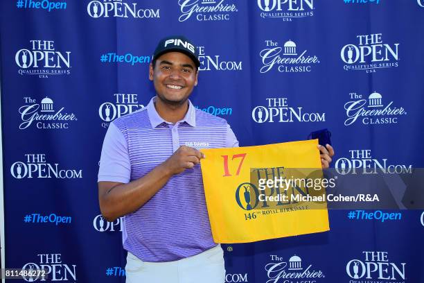 Sebastian Munoz of Colombia holds a hole flag after qualifying for the Open Championship during the fourth and final round of The Greenbrier Classic...