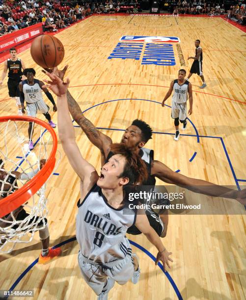 Ding Yanyuhang of the Dallas Mavericks blocks the shot against Derrick Jones Jr. #10 of the Phoenix Suns during the 2017 Summer League on July 9,...