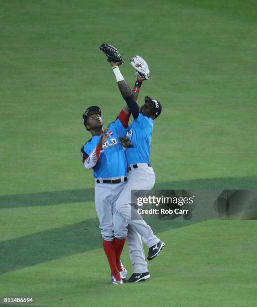 Estevan Florial of the New York Yankees and the World Team catches the ball over teammate Victor Robles of the Washington Nationals against the U.S....