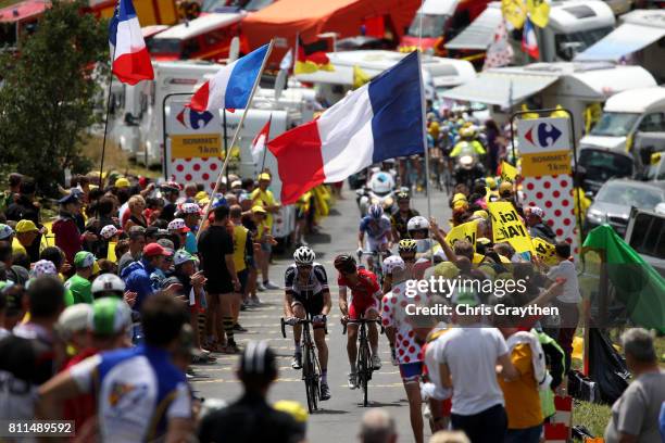 Tony Gallopin of France riding for Lotto Soudal and Jan Bakelants of Belgium riding for AG2R La Mondiale ride up the col du Grand Colombier during...