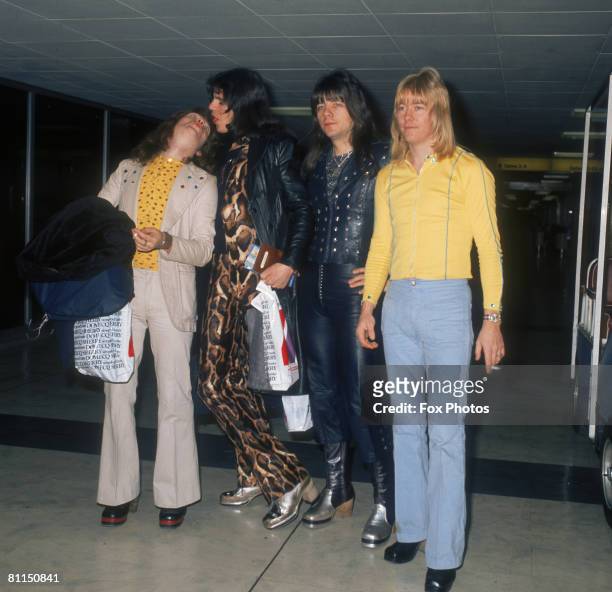 British glam rock group The Sweet, Steve Priest, Mick Tucker , Andy Scott and Brian Connolly at Heathrow Airport, November 1973.