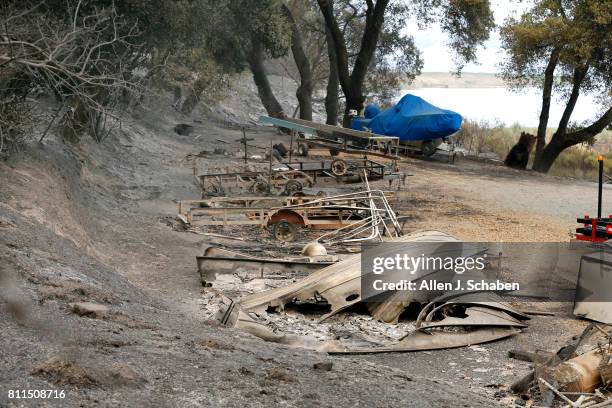 The remains of a structure and boats scorched by the Whittier Fire along SR-154 in the Los Padres National Forest near Lake Cachuma, Santa Barbara...